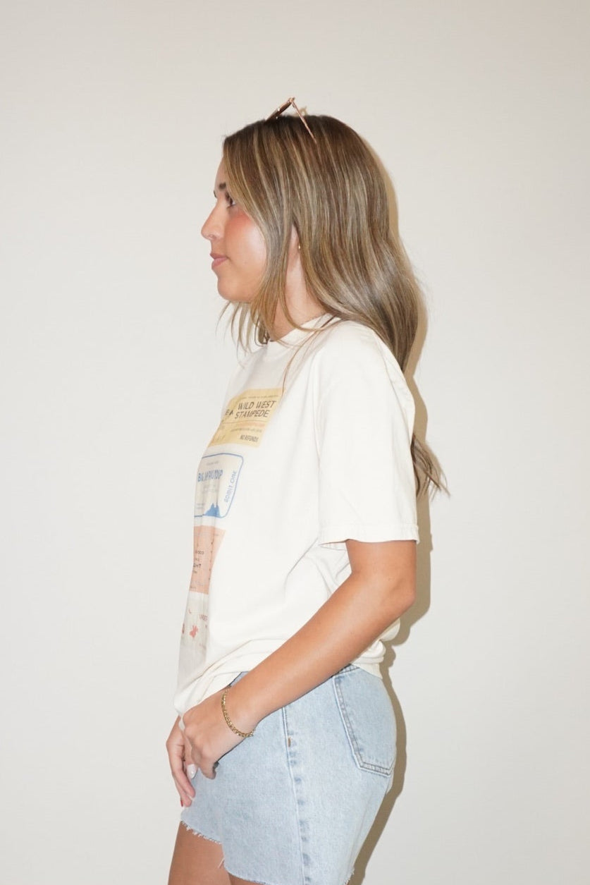 Person wearing a white shirt and light blue shorts standing on a checkered floor.